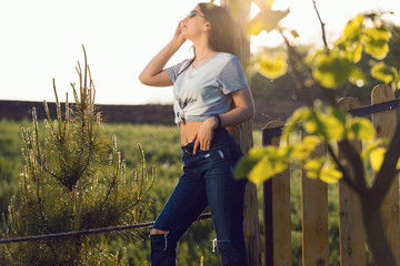 Beautiful smiling girl wearing casual summer clothes enjoys sunny day. Beauty, fashion shot.