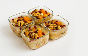 Traditional Turkish Dessert Ashura or Noah's Pudding in glass bowls on white with copy space.