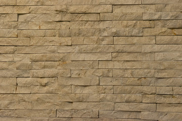 pared antigua de piedra espacato, piedra rectangular, textura rocosa color beige.
