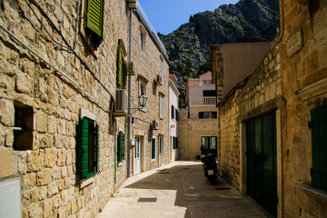 Fototapeta na wymiar Narrow street in the old town of Omis in Croatia - Stone houses by the mountains on the Makarska riviera