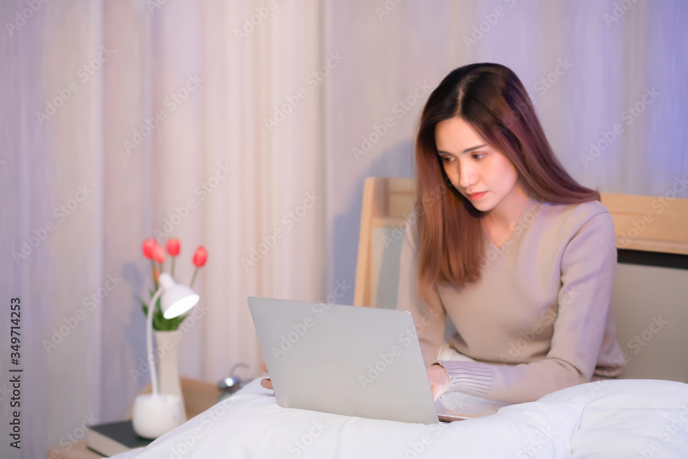 Wall mural a beautiful woman with long hair. asian people. thai people wear long-sleeved shirts sitting and typ