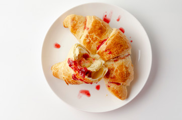 Delicious breakfast with croissants and coffee and spring flowers on the white background