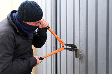 Burglar breaking into a garage