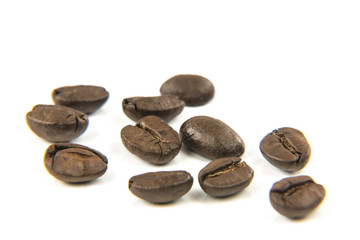 Fototapeta na wymiar Close-up Of Roasted Coffee Beans Against White Background