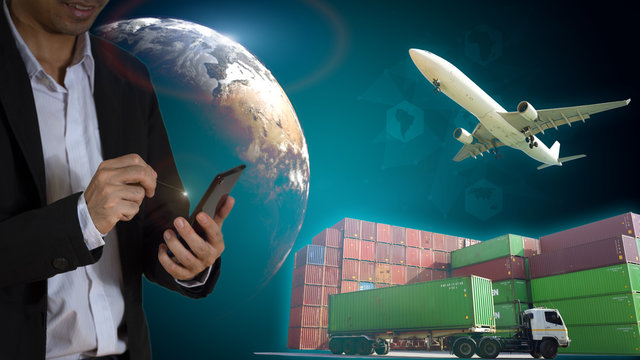 Businessman using a pen point to smartphone. Logistic background and Aviation business Concept. Business transportation and cargo. Elements of this image furnished by NASA.