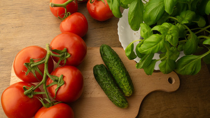 
Vegetables. Tomatoes and cucumbers with basil. Ready free entry space