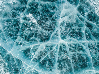 Beautiful cracks surface of the frozen lake of Baikal lake with frost methane bubbles in winter season. Baikal is the largest freshwater lake and the world's deepest lake.
