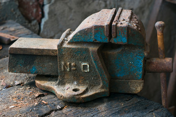 An old and rusty central forge. Bench vise.