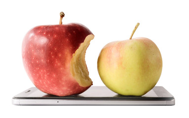 One red apple with a bitten side and one yellow apple on a smartphone on a white background