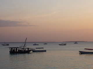 Naklejka premium A beautiful sunset with a ship returning to port, Nungwi, Zanzibar, Tanzania