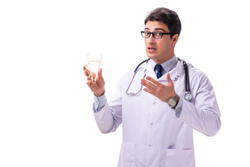 Young male doctor with calipers isolated on white
