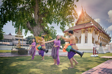 Young asian people are dancing long drums which is the Thai folk art and culture at temple which is...