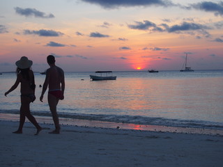 Man and woman walking on the beach, Nungwi, Zanzibar, Tanzania