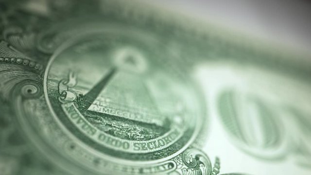 Macro close up of US one dollar bill pyramid eye symbol often associated with illuminati conspiracy theory