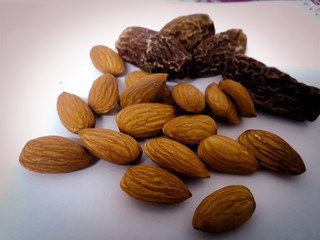 Healthy almons and dates are ready to be consumed.