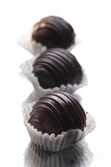 Eclairs on a muffin cup, three cakes, small cakes with chocolate icing