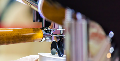 Espresso Machine pouring fresh coffee into cups at Local Coffee Shop..