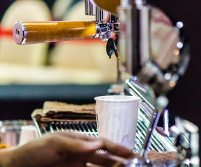 Espresso Machine pouring fresh coffee into cups at Local Coffee Shop..