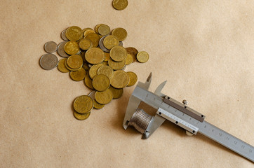 Group of various coins and vernier caliper.