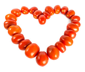 A heart laid out of whole red tomatoes isolated on a white background