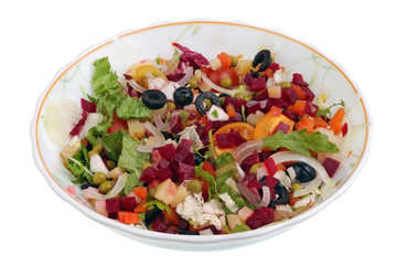 Rural  salad with vegetables and feta cheese in a glass  plate  isolated