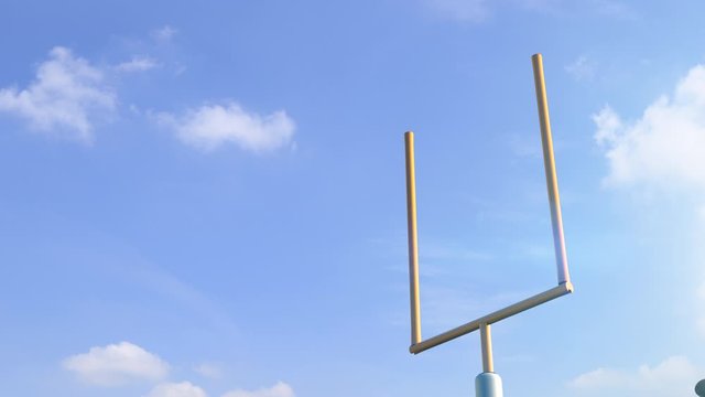american football ball through goal post in blue sky