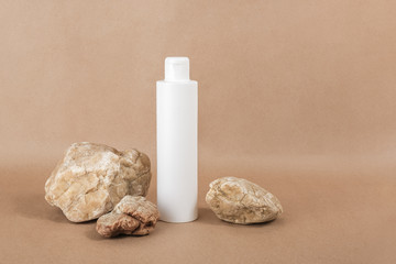 White blank cosmetic bottle with cream, moisturizing lotion or shampoo background on beige craft paper background. Natural Organic Spa Cosmetic concept Front view