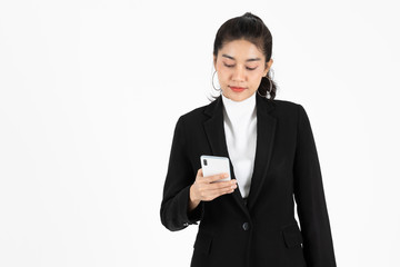 Fototapeta premium Attractive young Asian business woman holding mobile smart phone over white isolated background. Social network, Internet Of Things concept.
