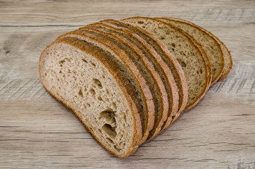 slices of rye bread on a wooden background.