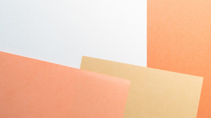 Colorful pastel paper stacks background. Abstract white beige copper brown colors. Minimalism geometric flat lay backdrop