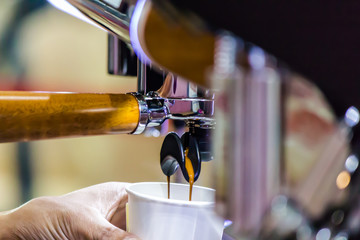 Espresso Machine pouring fresh coffee into cups at Local Coffee Shop..