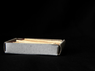 Matchbox and matches close up on a black background