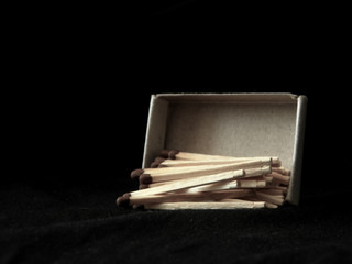 Matchbox and matches close up on a black background