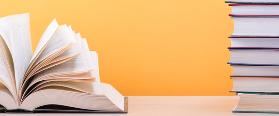 The book is open, lying on the table, the sheets spread out like a fan on a yellow background.