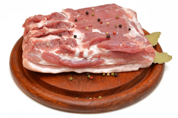 pork on a wooden board piece of raw meat isolated on a white background