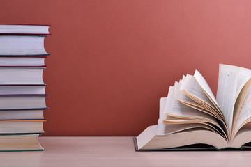 The book is open, lying on the table, the sheets spread out like a fan on a brown background.