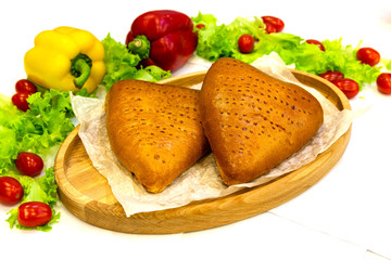 Pie, tart, pastry, baked gate with filling on a plate on the table, lunch, fast food

