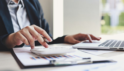 Fototapeta premium Accounting businessmen are calculating income-expenditure and analyzing real estate investment data, Dedicated to the progress and growth of the company, Financial and tax systems concept.