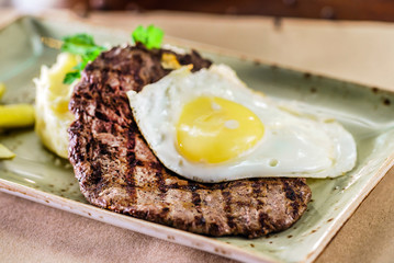 steak with egg and mashed potato