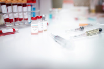 Sample of coronavirus vaccine (COVID-19) on work table in a medical lab.