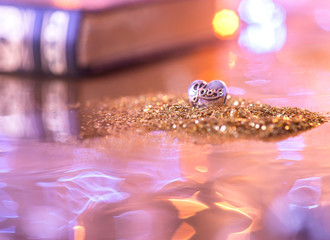 golden christmas lights. heart on a bright background. closeup of jewelry. silver jewelry