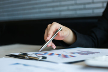 Financial businessmen analyze the graph of the company's performance to create profits and growth,...