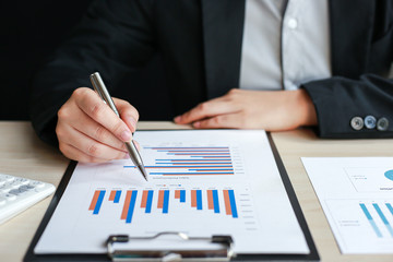 Financial businessmen analyze the graph of the company's performance to create profits and growth, Market research reports and income statistics, Financial and Accounting concept.
