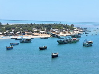 Fototapeta na wymiar fishing boats in the harbor. Drone Shot taken over the small island of Rameswaram. Boats and harbours of fishing. Vast blue ocean. Simple living of inhabitants of island. Slow life. Aerial photography