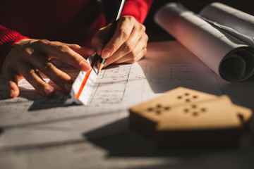 Architect working on blueprint. Architects workplace - architectural project, blueprints, ruler, calculator, laptop and divider compass. Construction concept. Blue print is fake only for stock photo.