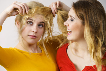 Two girls creating hairdo. Hair ombre color