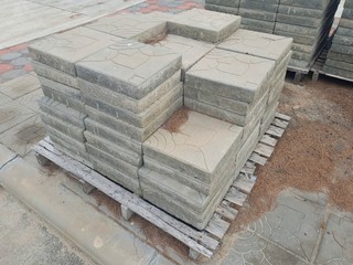 Drawing shape textured Paver stone regular blocks lay on the pallet at the road side walk
