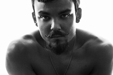 Black and white portrait of a man close up. Emotional portrait of a man with a mustache and beard.