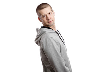 Fototapeta premium A sporty confident athlete man turned his back. A look into the camera. Isolated