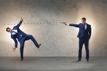 Businessman with gun threatening his competitor